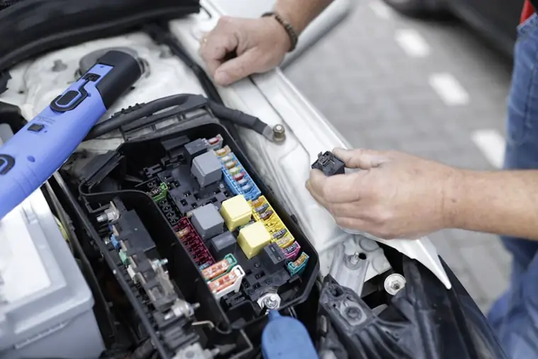 Car mechanic working on automotive electronics